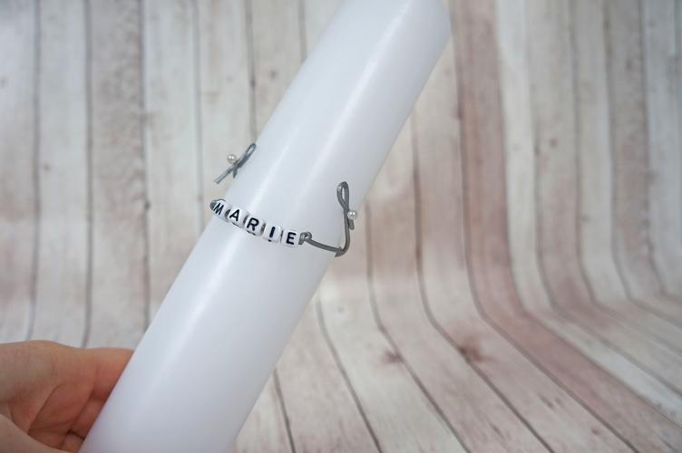 Attach the name bracelet to the baptism candle